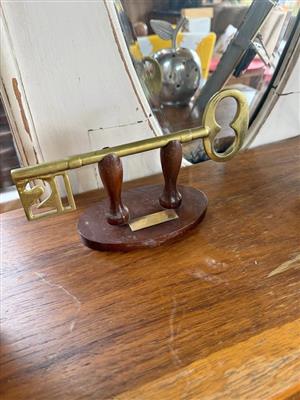 Brass 21 year birthday key on stand