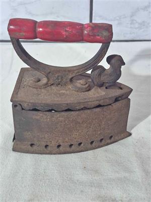 Vintage cast iron charcoal iron, often referred to as a "sad iron" or "coal iron".