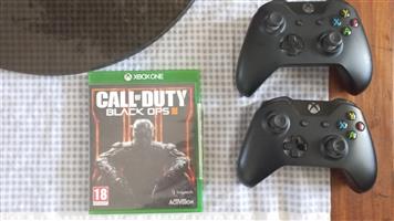 2× xbox one controller first generation  and a copy of call of duty: black opps.