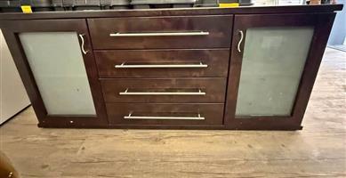 Solid wooden sideboard with cupboards and drawers. 