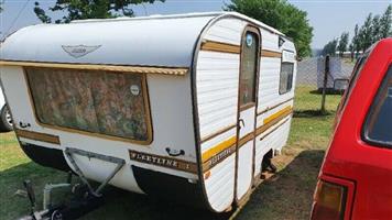 jurgon caravan for sale. with papers, has two axle, one front window broken.