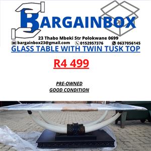 GLASS TABLE WITH TWIN TUSK TOP