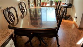 Walnut Dining Table with protective glass top with matching chairs. 