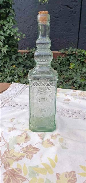 Vintage glass bottle, widely recognized as the "Miguelete".  