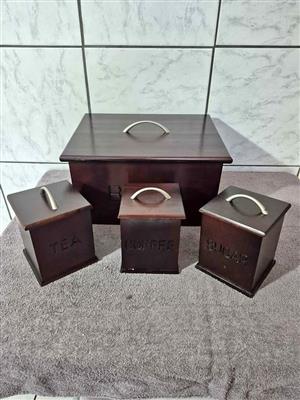 Beautiful vintage dark wood bread box and matching tea, coffee, and sugar canisters.