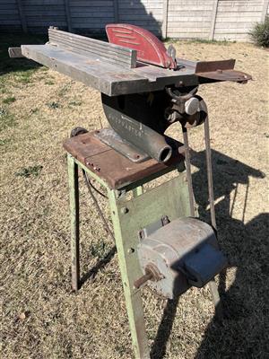 Shopmaster circular saw mounted on steel frame with electric motor.