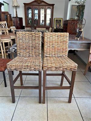 Set of 2 Woven Rattan Bar Stools - Solid wooden legs and dark wood finish.