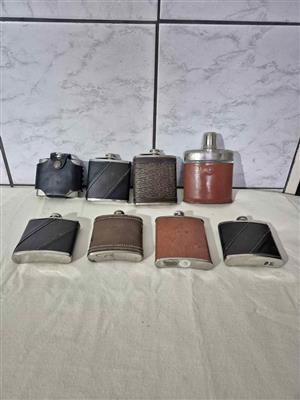 Collection of vintage, leather-wrapped hip flasks