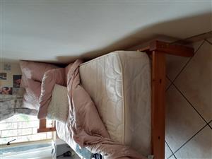 Two wooden single beds with matresses for sale