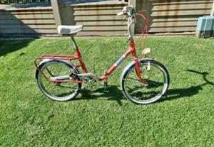 3 vintage fold up bicycles.