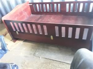 Toddler bed in dark wood with foldable sides