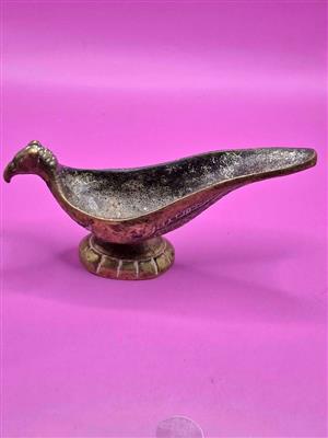 Vintage brass or bronze pipe holder in the shape of a bird