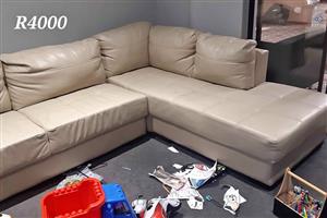 Cream-colored, L-shaped leather sectional sofa 
