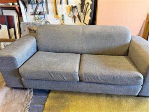 Grey Two seater sofa in soft upholstery material