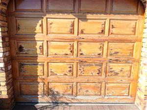 Three used wooden (meranti) garage panel doors. 