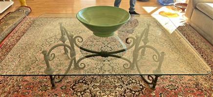 Glass coffee table on wrought iron base. Size Length 157, Width 117. Good condition.
