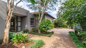 Landscaped garden and sparkling swimming pool.
