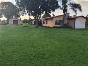 Perfectly situated farmhouse with the entrance to R104 with large storage / work