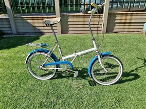 3 vintage fold up bicycles.