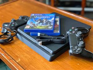 Negotiable | PS4 Slim Premium Bundle – 2 Controllers + External HDD + Games | 