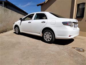 It is White Toyota Corolla Quest 2015, manual. It is in good condition.