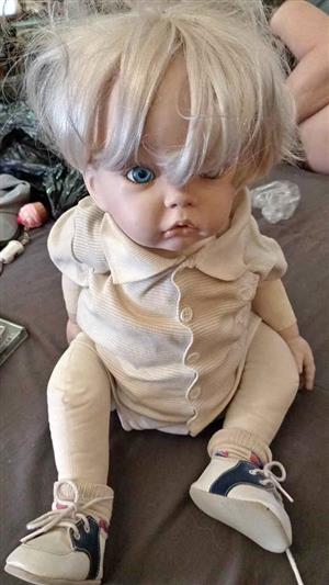 Life like reborn"( bisque) or porcyline doll.