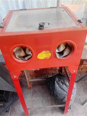 Sandblasting cabinet with sand