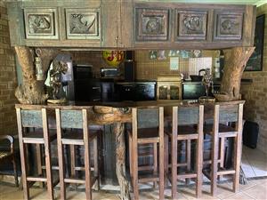 One of a kind, big five hand carved Iron wood and sleeper bar counter