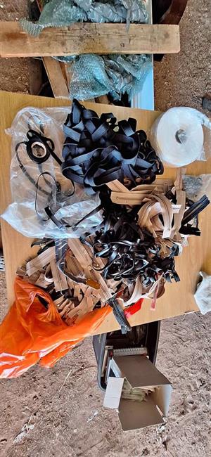 Textile materials and sewing supply scrap pile.  It includes a large quantity of beige and black zip