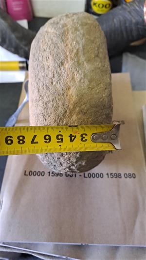 Bushman digging stone