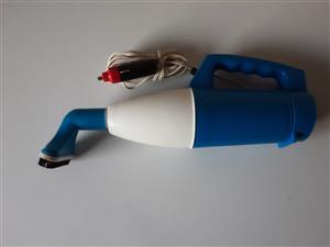 Handheld Vacuum Cleaner with long cable and cigarette lighter plug.