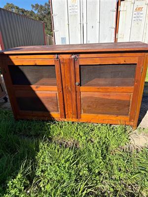 Vintage wooden cabinet with traditional mesh panel for storing meat