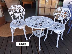 Two styles of new, cast-aluminium, white, two-seater patio sets