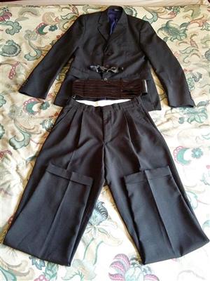 Men’s black suit with bowtie and cummerbund.