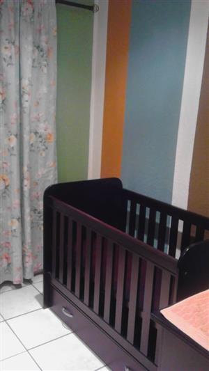 Baby cot in dark wood with bottom drawer and bamboo mattress