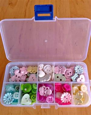  Assorted craft & sewing buttons in clear organizer boxes.