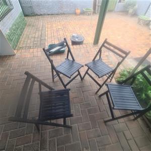 4 black wooden fold up chairs 