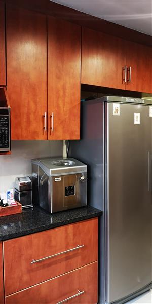 Kitchen cupboards, granite countertops, stove, extractor fan, sink and mixer