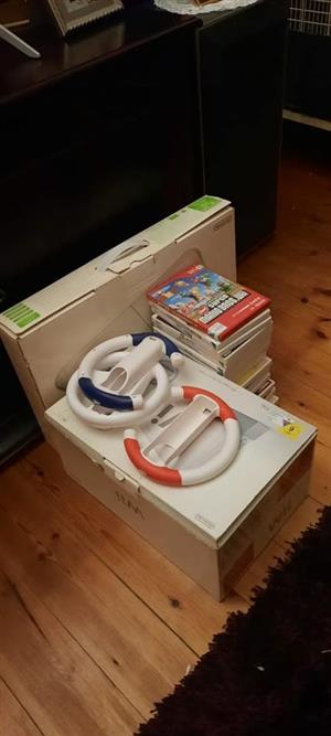 Wii  with 4 remotes, 4 joysticks,  3 steering wheels