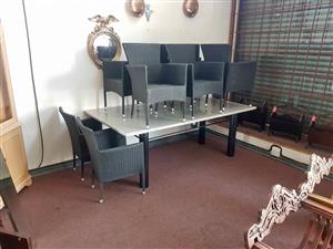 This Emalfi Promenade wicker dining set features a granite top table paired with eight  durable, syn