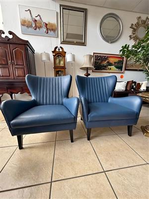 A Pair of Winged Armchairs in Blue Genuine Leather (priced per chair)