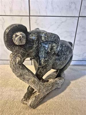 A large hand-carved African stone sculpture of an elephant