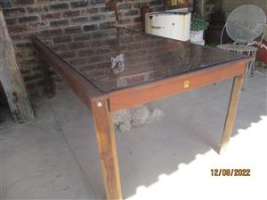 Wooden Table. with glass top.