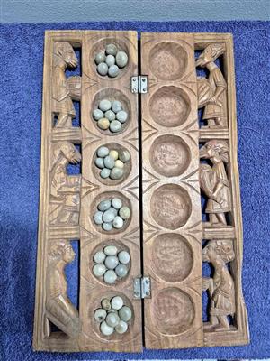 Vintage handcrafted wooden Mancala board, a traditional strategy game popular across Africa